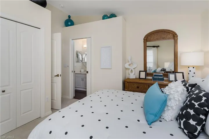 Cream-toned walls complement light-colored carpet flooring