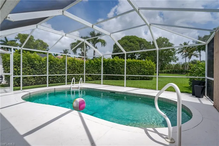 Screened-in outdoor pool featuring a curved design and white deck surround