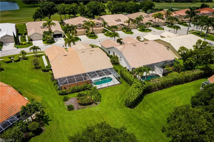 Aerial view of a residential property featuring a screened-in swimming pool