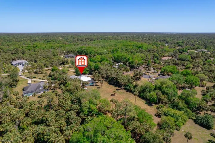 Rear Aerial view featuring a wooded view