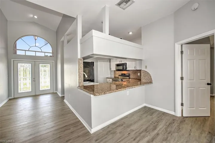 Kitchen featuring white cabinets
