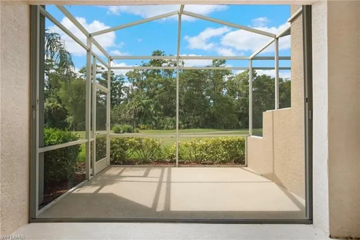 Rear Screened-in Lanai with hurrican shutters, dining area and seating area - View of both sunrise and sunset!