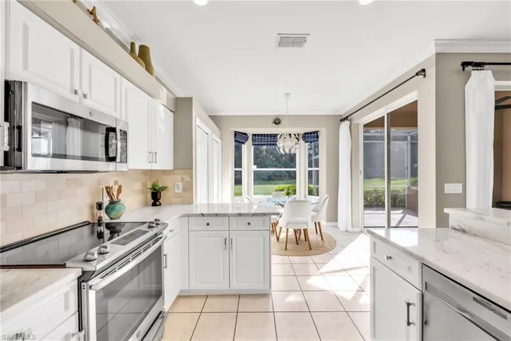 New refreshed kitchen with all stainless steel aplliances, natural stone counters and backsplash - open living area makes it feel expansive yet intimate.