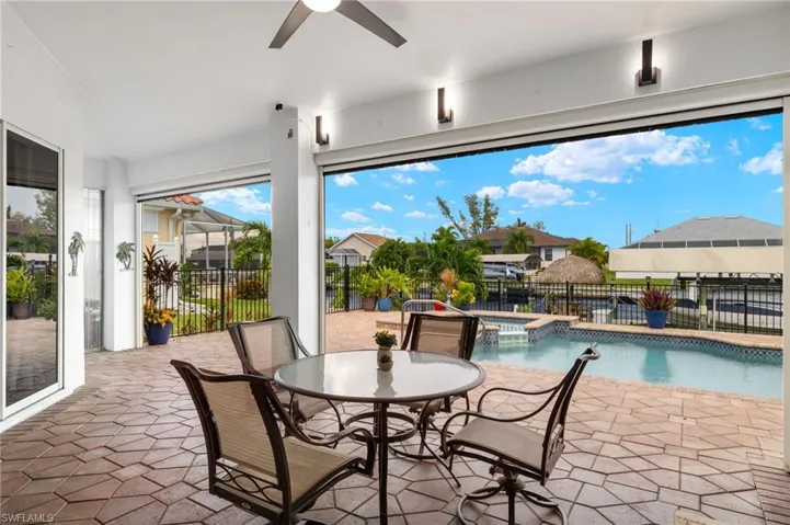 View of patio / terrace featuring ceiling fan and a fenced in pool