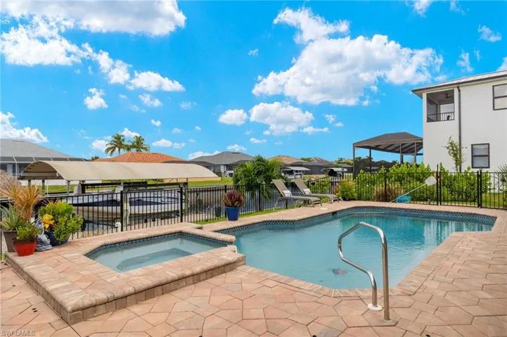 View of pool with an in ground hot tub and a patio area