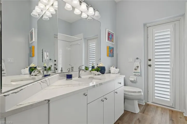 Bathroom with vanity, toilet, and hardwood / wood-style flooring
