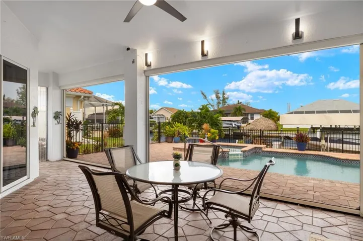 View of patio featuring a fenced in pool and ceiling fan
