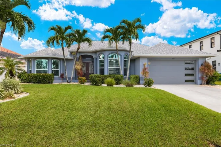Ranch-style house with a garage and a front yard