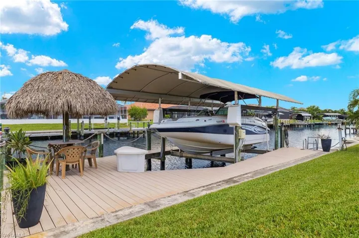 Dock area featuring a lawn and a water view