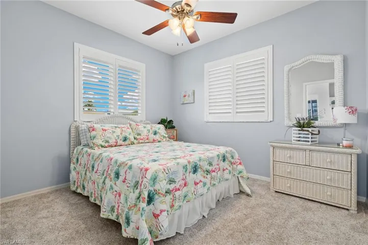 Carpeted bedroom with ceiling fan