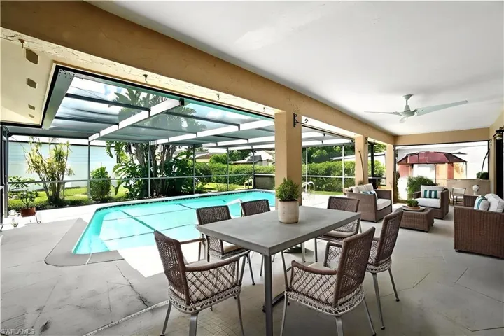 Patio set with table and sitting area are virtually staged.