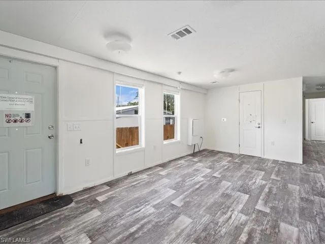 Spare room with visible vents, wood finished floors, and a textured ceiling