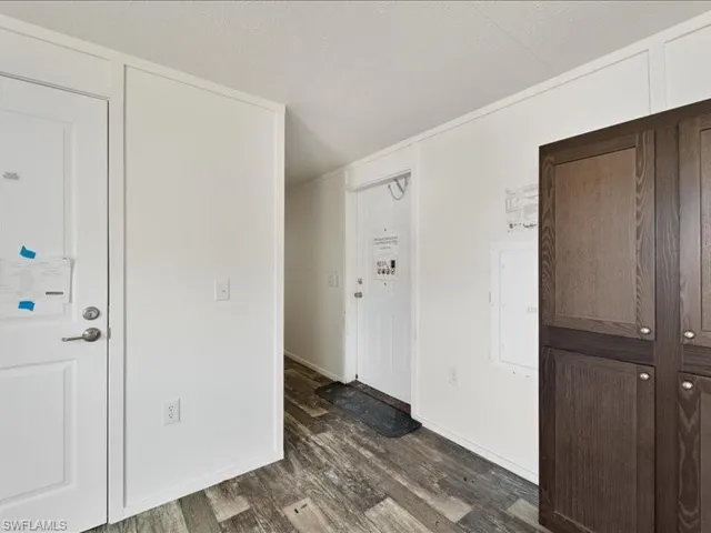 Entrance foyer featuring dark wood-style floors