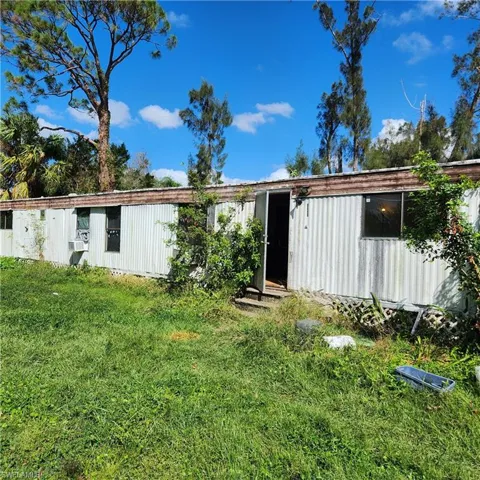 Back of house featuring a yard