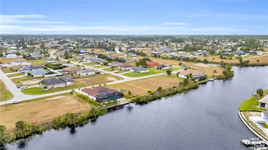 Birds eye view of property with a water view