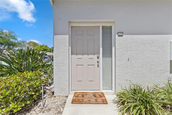 View of exterior entry featuring stucco siding