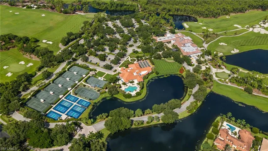Birds eye view of property with a water view