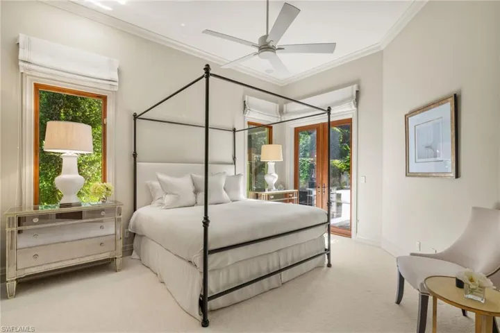 Bedroom featuring french doors, light colored carpet, crown molding, access to outside, and ceiling fan