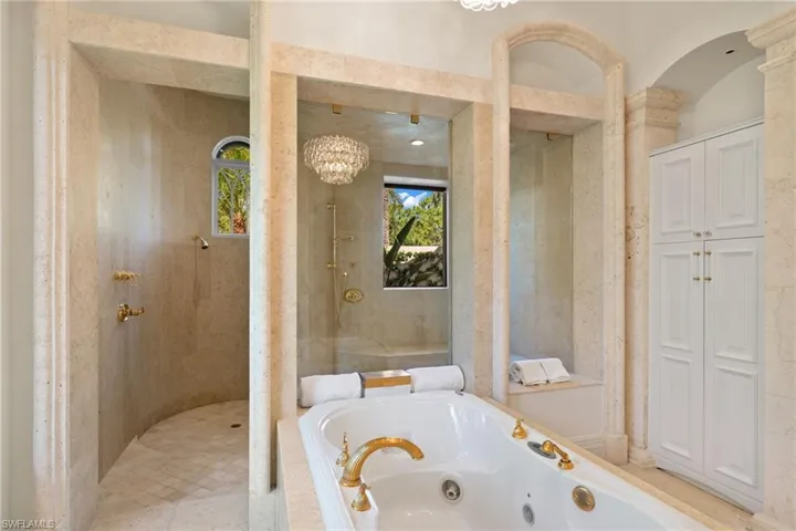 Bathroom with shower with separate bathtub and tile patterned flooring