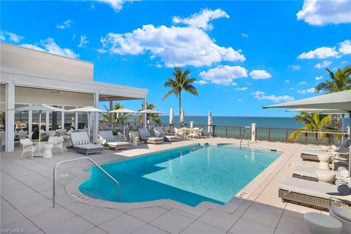 View of swimming pool featuring a patio area and a water view