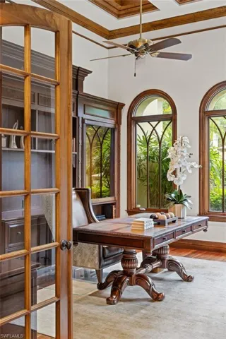 Dining room featuring ornamental molding, wood-type flooring, a wealth of natural light, and coffered ceiling