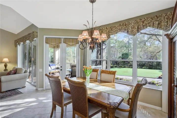 Dining area featuring light tile patterned flooring and hanging lights