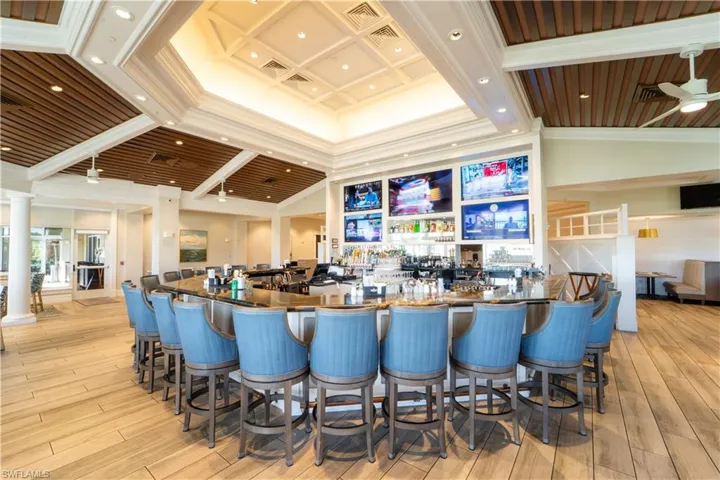 Community bar area featuring dark countertops, ceiling fan, ornamental molding, and recessed lighting