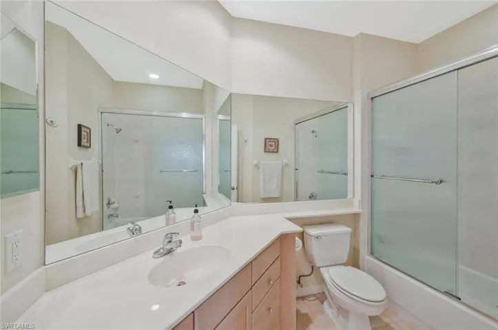 Full bath featuring vanity and enclosed tub / shower combo