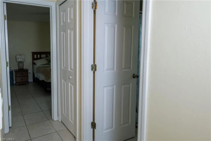 Corridor with light tile patterned flooring