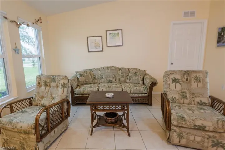 Living room featuring healthy amount of natural light and light tile patterned floors