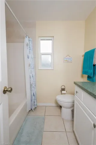 Full bathroom featuring vanity, tile patterned floors, and shower / bath combo