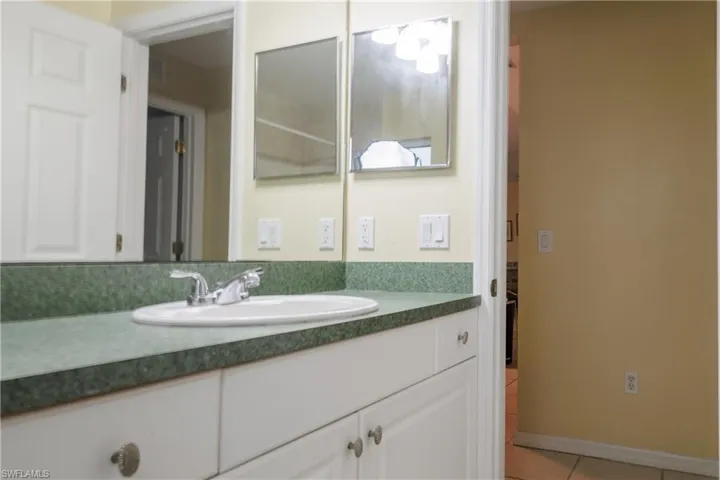 Bathroom with tile patterned flooring and vanity