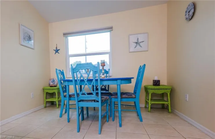 Dining area featuring light tile patterned flooring