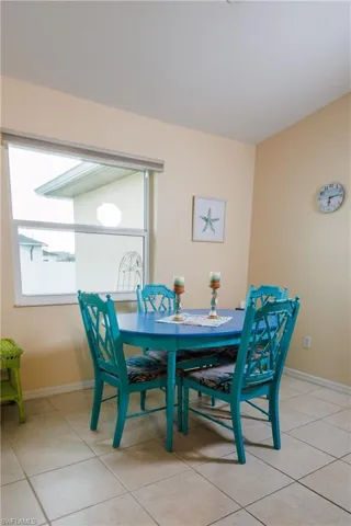 Dining space featuring light tile patterned floors