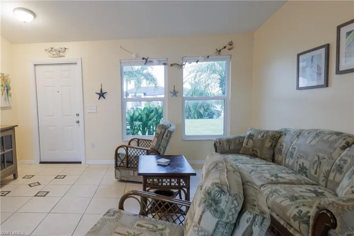 Living room with light tile patterned floors and baseboards