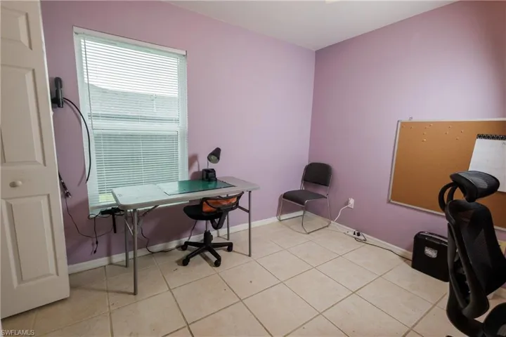 Office space featuring baseboards and light tile patterned floors