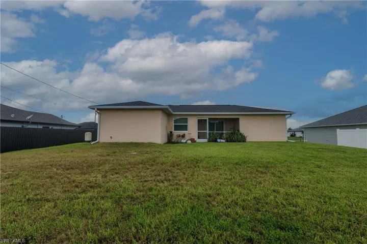Rear view of house with stucco siding