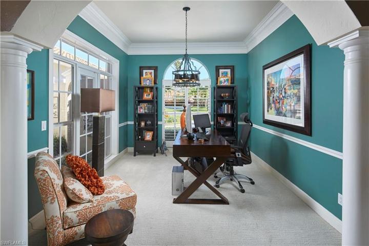 Den/study with plenty of natural light, located just off living room and overlooking a small courtyard and fountain.