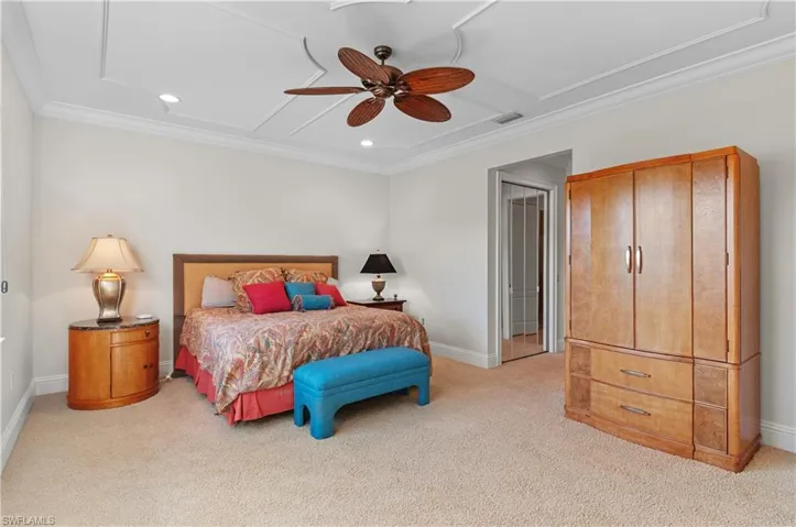 Bedroom featuring crown molding, light colored carpet, and ceiling fan
