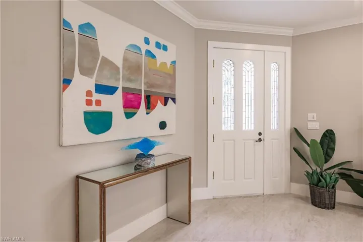 Foyer entrance featuring ornamental molding