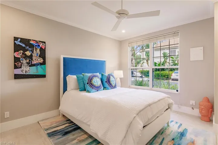 Bedroom with crown molding and ceiling fan