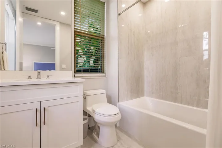 Full bathroom featuring vanity, toilet, and tub / shower combination
