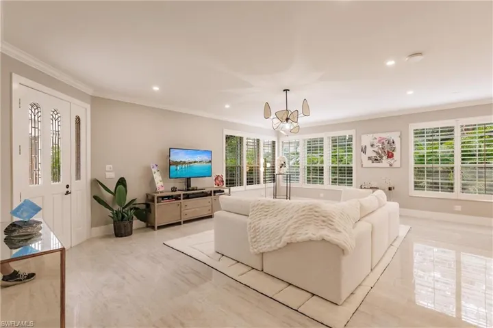 Living room with a chandelier and crown molding