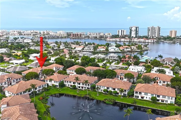 Birds eye view of property with a water view