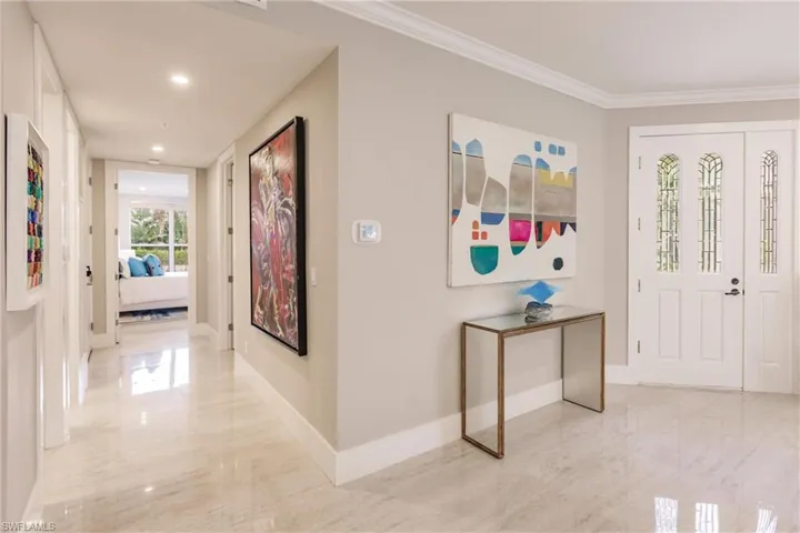 Hallway featuring crown molding