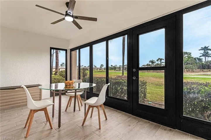 Sunroom featuring french doors and wood finished floors