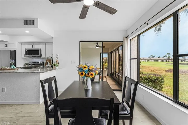 Dining area featuring ceiling fan, visible vents, and baseboards
