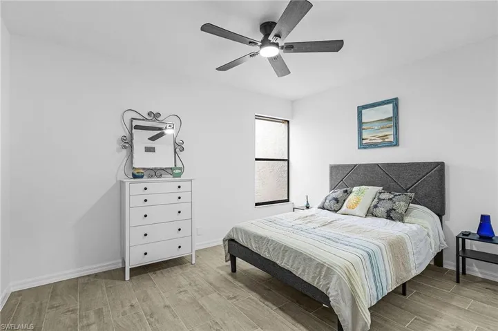Bedroom with baseboards, a ceiling fan, and wood finished floors