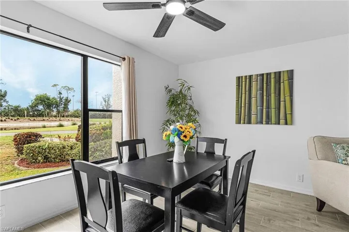 Dining space featuring ceiling fan, baseboards, and light wood-style floors