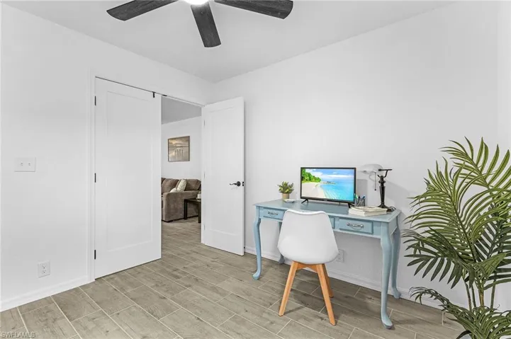 Office featuring baseboards, ceiling fan, and wood finish floors